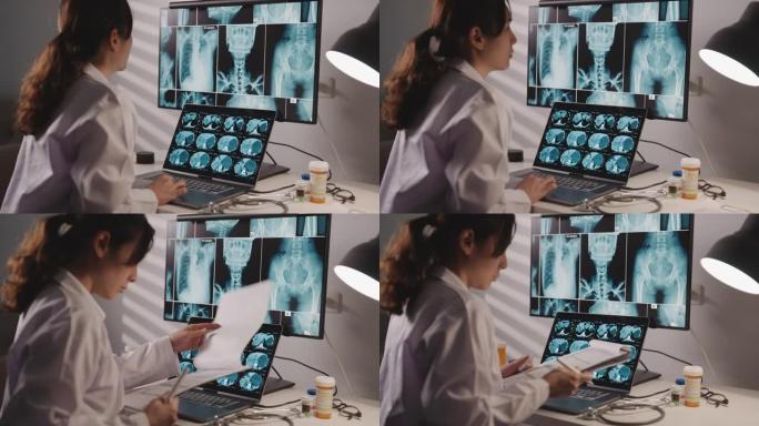 亚洲女医生在计算机上观察并分析x射线图像扫描