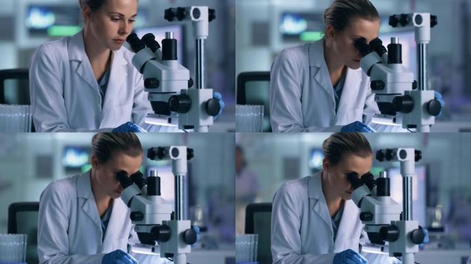 一名年轻女子在实验室使用显微镜的4k录像
