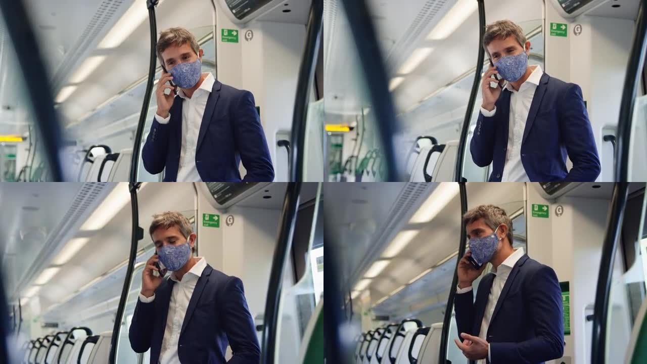 大流行期间，商人站在火车车厢上戴着PPE口罩用手机聊天