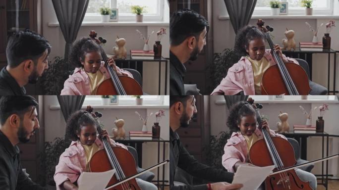 男人教女孩演奏低音提琴