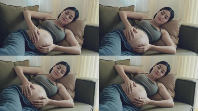 亚洲孕妇用手抚摸和触摸腹部时的腹部