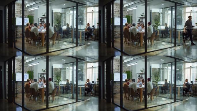 在现代化的办公室会议室中，各种专业的商人聚会。创意团队讨论应用程序设计，分析数据，计划营销策略，破坏
