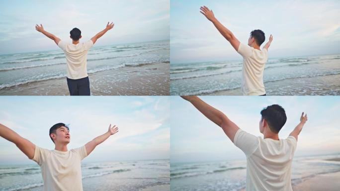 亚洲男子在海滩度假时散步并伸出手感到放松