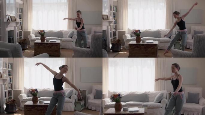 美丽的少女在家跳舞练习芭蕾舞动作在客厅排练