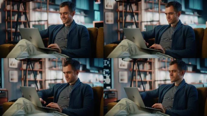 英俊的白人男子坐在时尚舒适的客厅的沙发上，在笔记本电脑上工作。自由职业者在家工作。浏览互联网，使用社