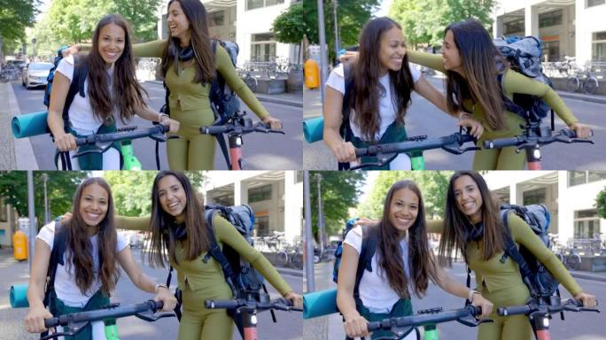 在城市中，两名女背包客带着踏板车