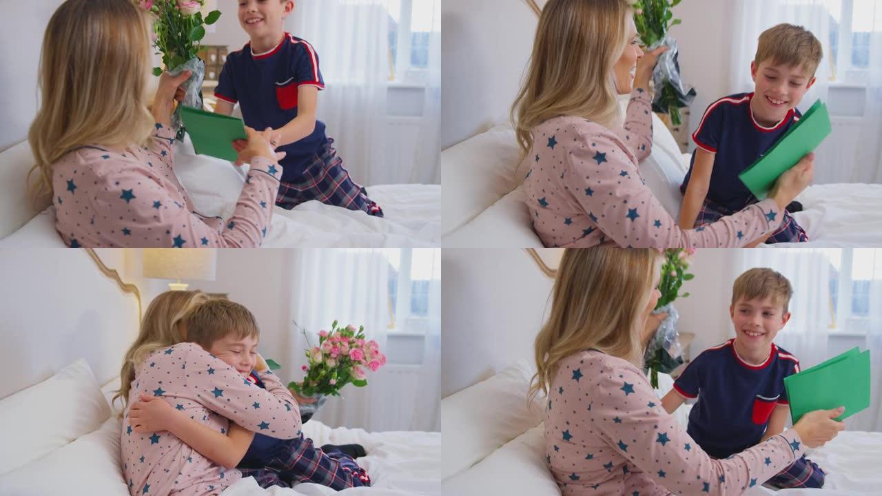 慈爱的儿子在生日或母亲节那天用鲜花和自制卡片使母亲在床上感到惊讶
