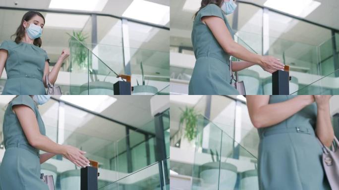 4k视频片段，一名年轻的女商人戴着口罩，在现代办公室里对双手进行消毒
