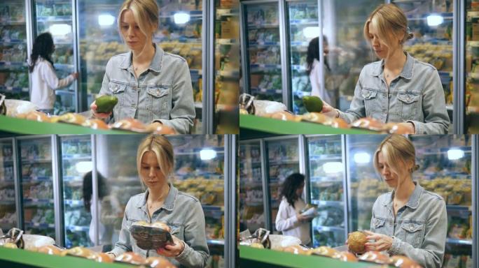 一个女人正在选择在超市买什么水果