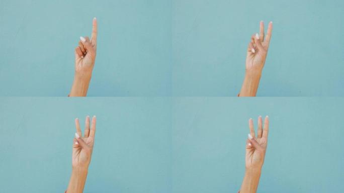 交流，手语和蓝色背景的倒计时。女人手指计数，数学和数字的全局符号或计时器。计数以指示挑战的开始或结束