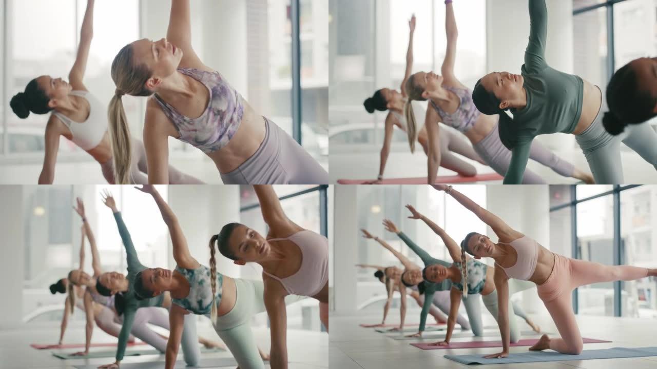 适合年轻女性在瑜伽馆举起一只胳膊和腿伸展。一群不同的女性为了健康的生活方式一起锻炼。瑜伽士在健身课上