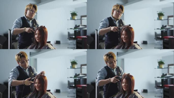 亚洲中国发型师女性卷发为她的顾客在发廊