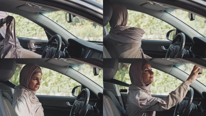 穆斯林妇女上车并系上安全带