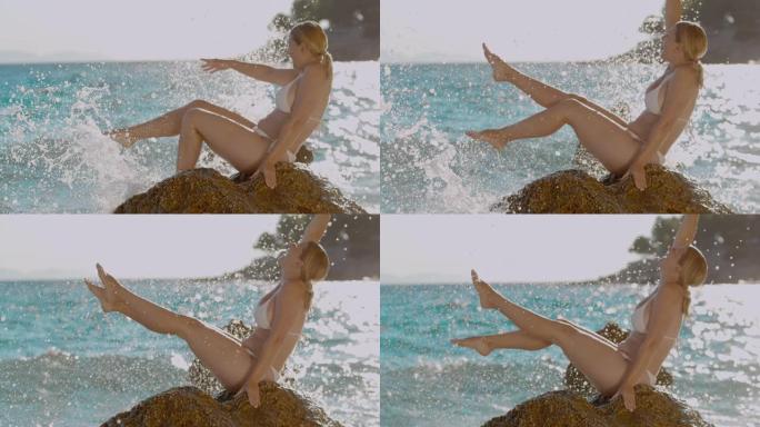 超级SLO MO女人喜欢海浪撞击岩石并喷洒她