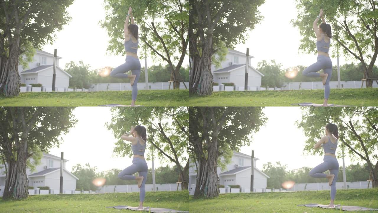 早上在户外公园的瑜伽课上锻炼女人