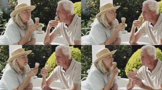 4k视频片段，一对老年夫妇坐在外面吃冰淇淋蛋筒