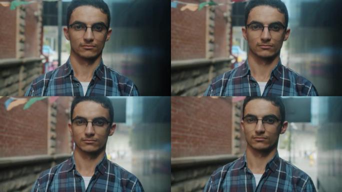 慢动作特写照片好看的阿拉伯年轻人戴着眼镜看着相机严肃的脸