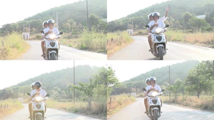 成熟的夫妇沿着乡间小路骑摩托车