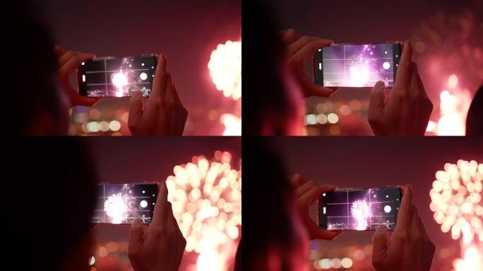 使用智能手机在庆祝烟花中拍照