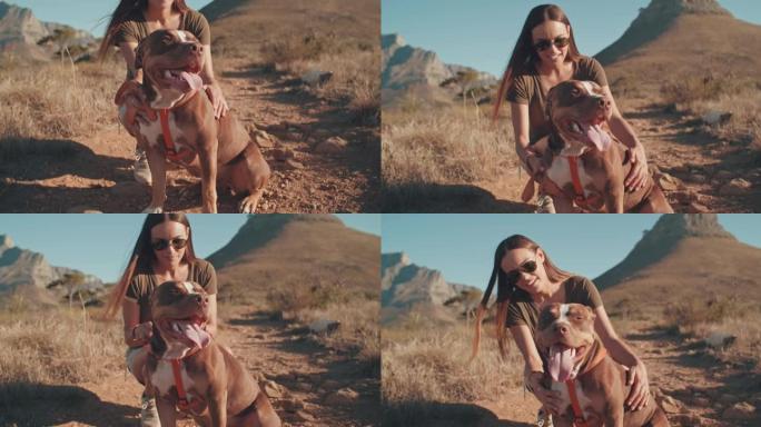 4k视频片段，一位迷人的年轻女子白天与她的狗一起徒步旅行