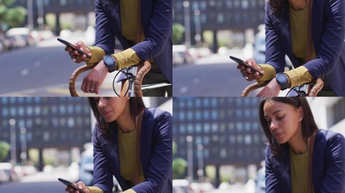 非裔美国妇女在骑自行车的街道上使用智能手机