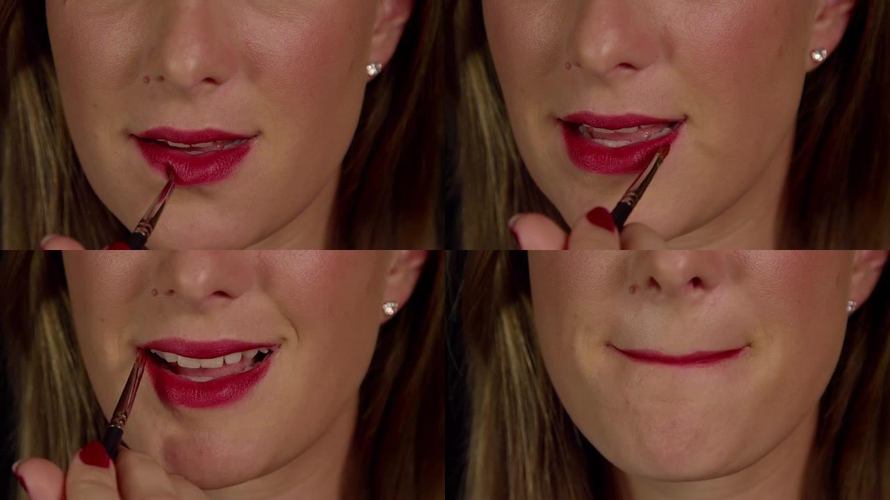 慢动作特写: 女人用刷子涂红色唇膏