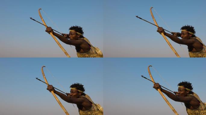 慢动作特写哈扎狩猎采集者部落成员旨在拍摄他的弓箭坦桑尼亚