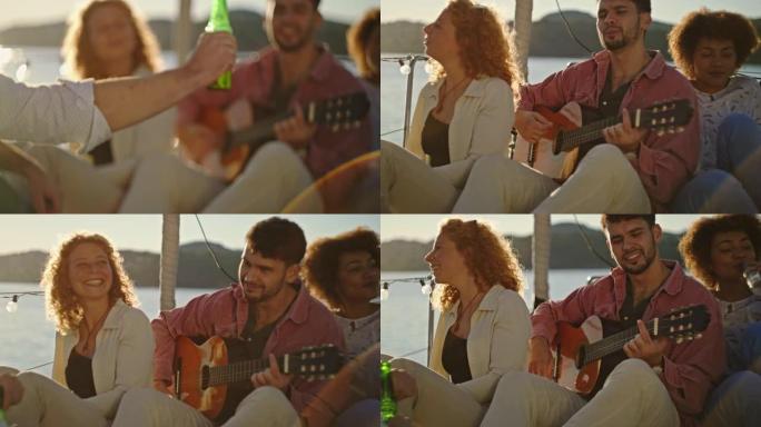 SLO MO Man在日落时在船上聚会时向他的朋友弹吉他