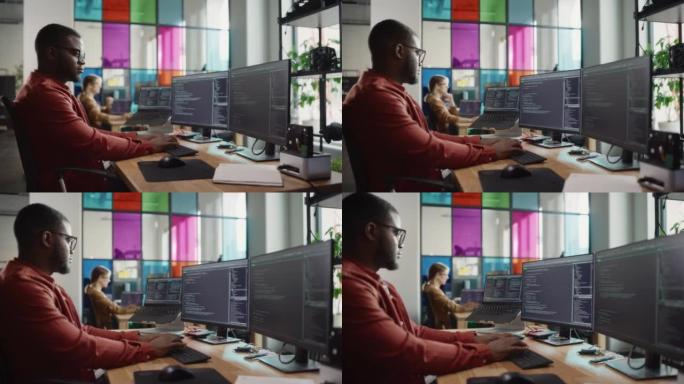 非裔美国人在台式计算机上编写代码，设置了多个显示器，并在Creative Office中使用笔记本电