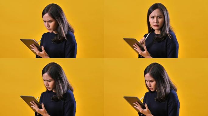 严肃的女人在黄色背景上使用数字平板电脑