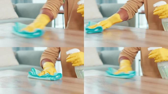 男人在家打扫桌子。男性用布擦拭和消毒桌子表面的特写镜头。忙于日常的家务和琐事，以获得整洁，卫生和无菌