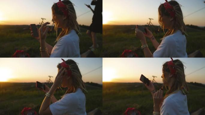 美丽的年轻女子在野外使用手机进行视频通话