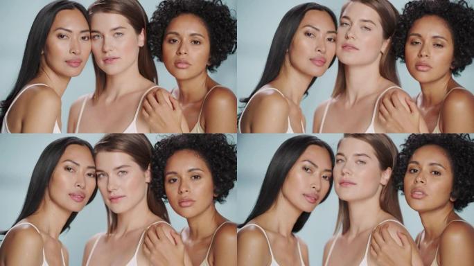 三个不同的多种族模型在孤立的背景上的美丽肖像。性感快乐的亚洲、黑人和高加索女性，拥有自然健康的皮肤。