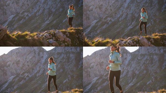 运动活跃的女人在山区的岩石小径和草坡上奔跑