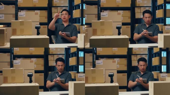 带有条码机和包装盒的亚洲商人在仓库快递之前，使用数字平板电脑检查货架上的库存和在线信息中的关键数据。