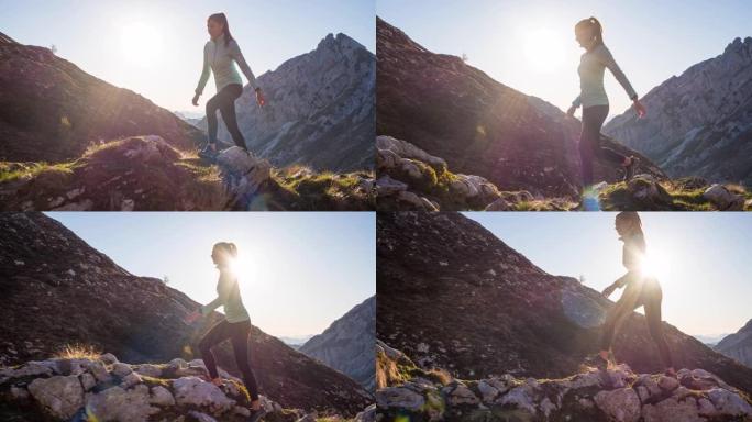 年轻女子在山区的岩石小径上坡散步