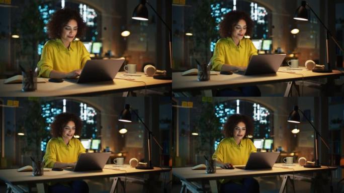 有动力的阿拉伯女性晚上坐在创意机构，经理为客户实施业务战略。兴奋的专家在笔记本电脑上编写公司项目计划