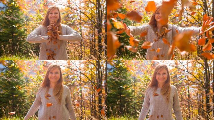 女人微笑着向镜头扔秋叶