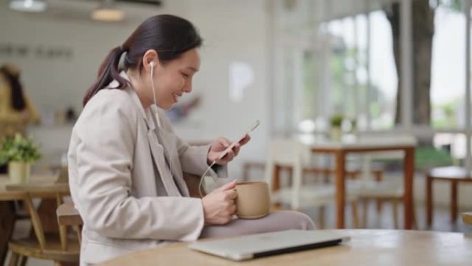 亚洲女商人在咖啡店使用智能手机