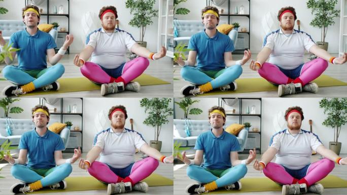 坐在莲花位置瑜伽垫上冥想享受活动的滑稽家伙的慢动作肖像