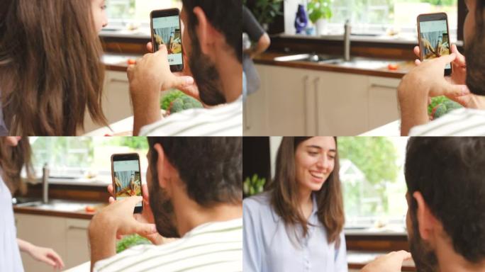 4k视频片段，一名男子向女友展示了他为她的烹饪拍摄的照片