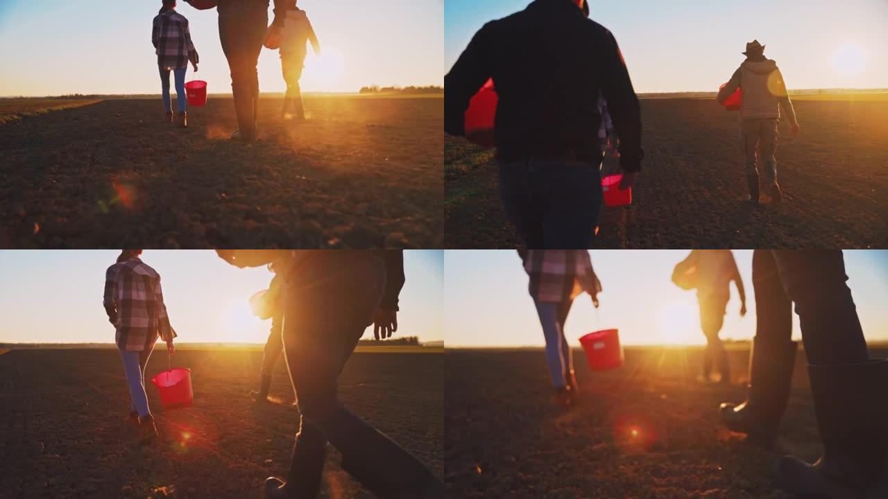 日落时分，三名农民拿着水桶穿过田野