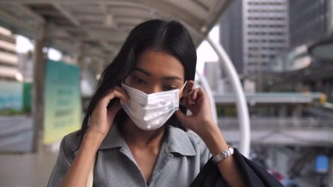 亚洲女商人戴上流感面具