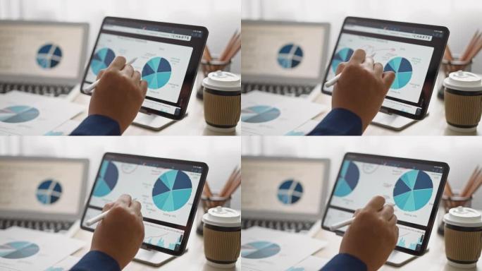 特写手牌商人分析数字平板电脑上的商业数据