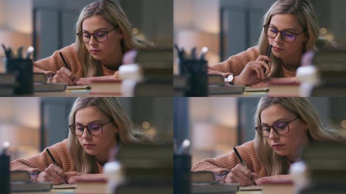 4k视频片段，一名年轻女子在学习时做笔记