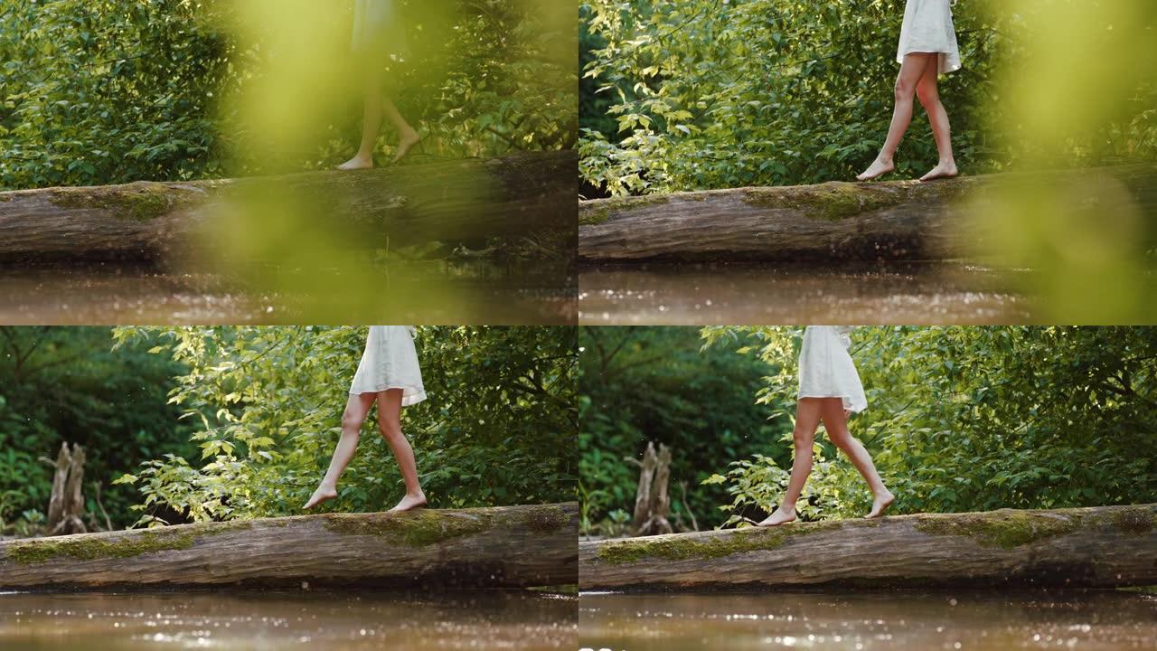 慢动作年轻女子走在树干上躺在水中