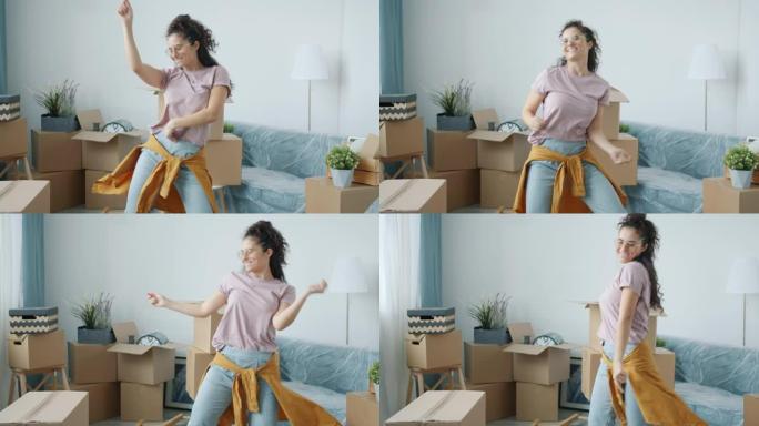 搬迁后，亚洲妇女在新家的空闲时间里享受音乐，在现代公寓里跳舞