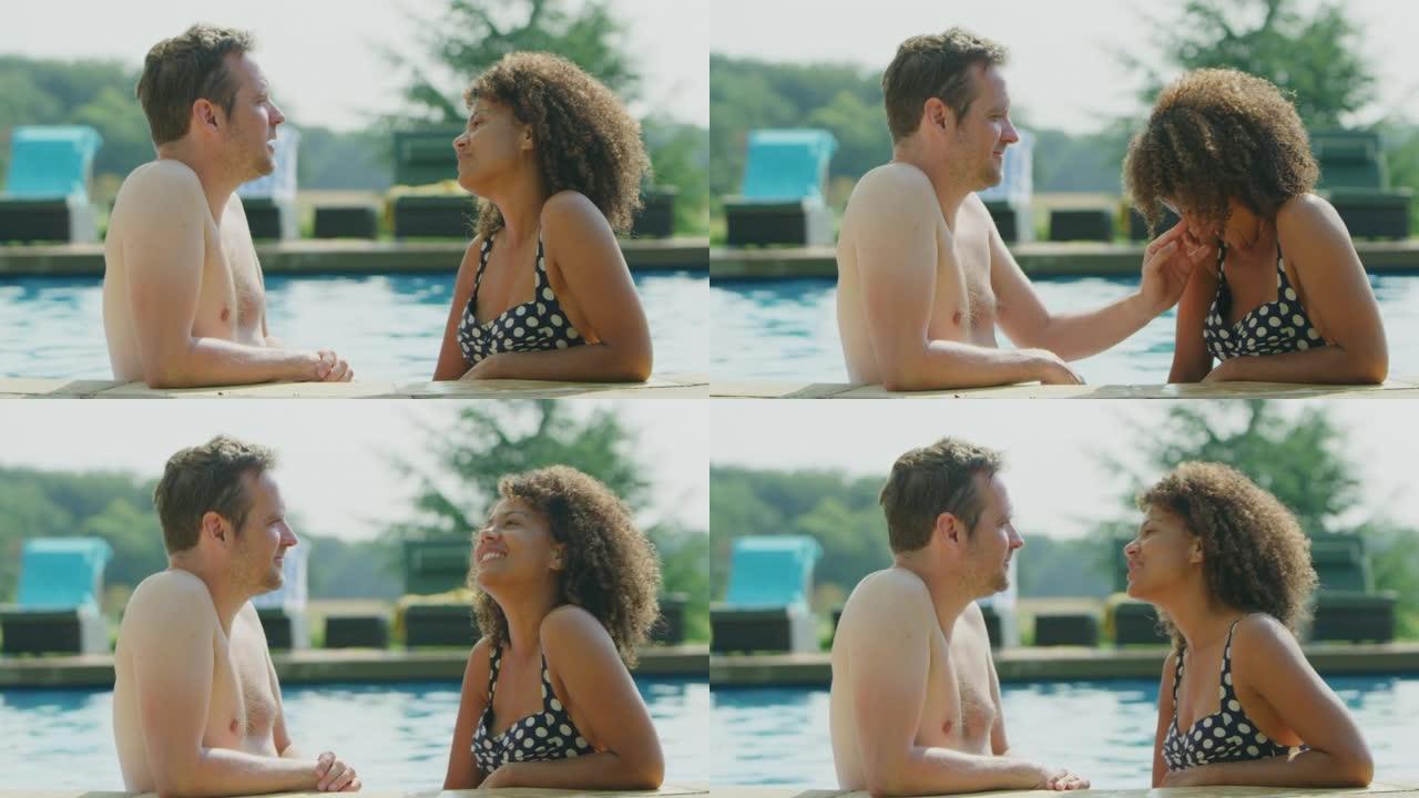 暑假成熟夫妇在室外游泳池边缘放松的侧视图 -- 慢动作拍摄