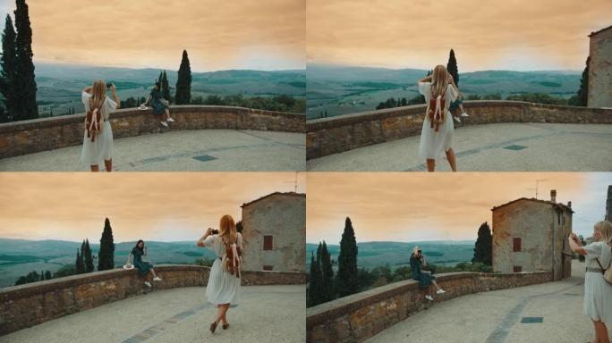 SLO MO年轻女子在Pienza的城墙上摆姿势