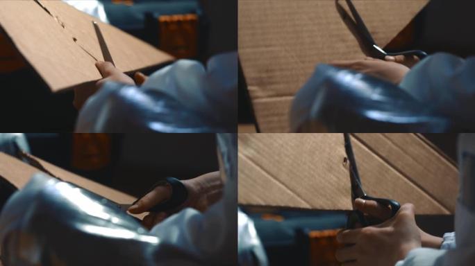 电影特写镜头，小孩的手挣扎着试图用剪刀从厚大的纸板上剪下身材